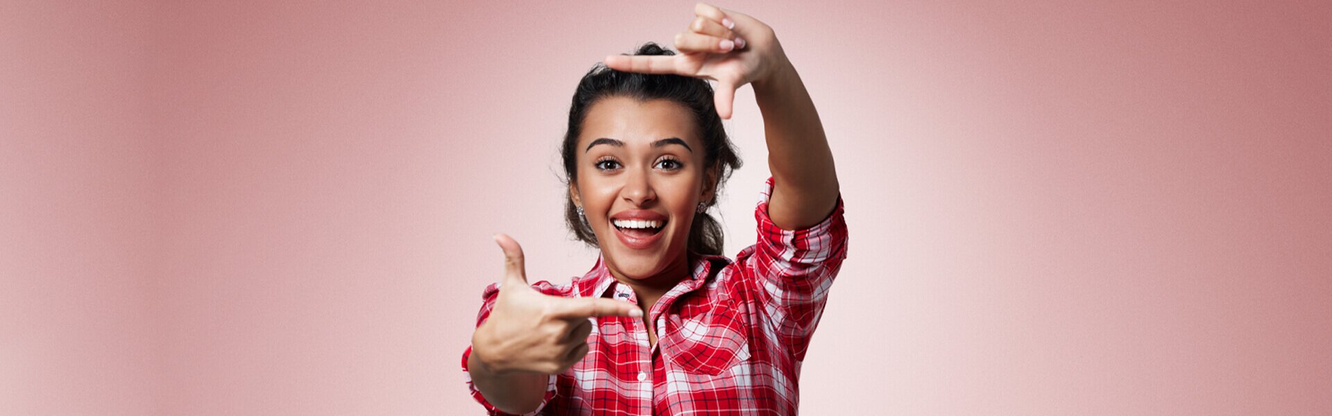 dentist patient model making a camera with her fingers and smiling